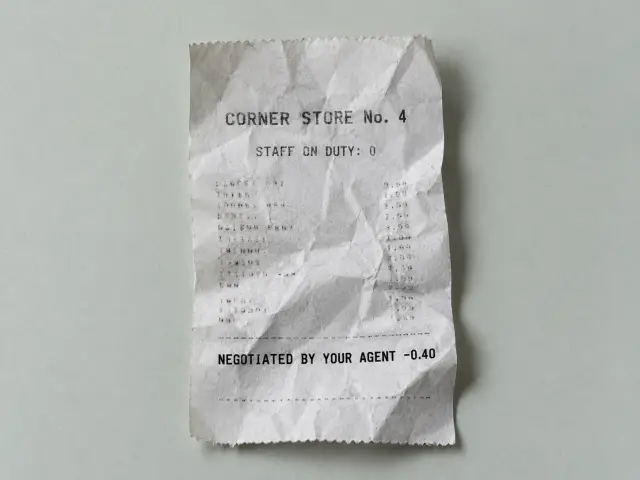 A crumpled thermal receipt from Corner Store No. 4, reading Staff on duty: 0, with a 40 cent discount negotiated by an agent.